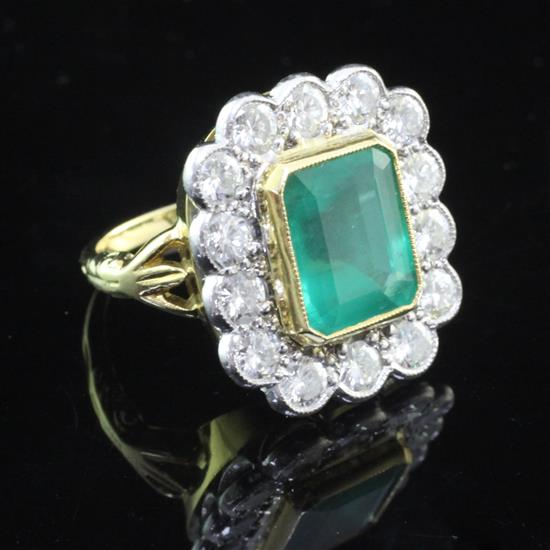 An unmarked gold, emerald and diamond cluster ring, size K.